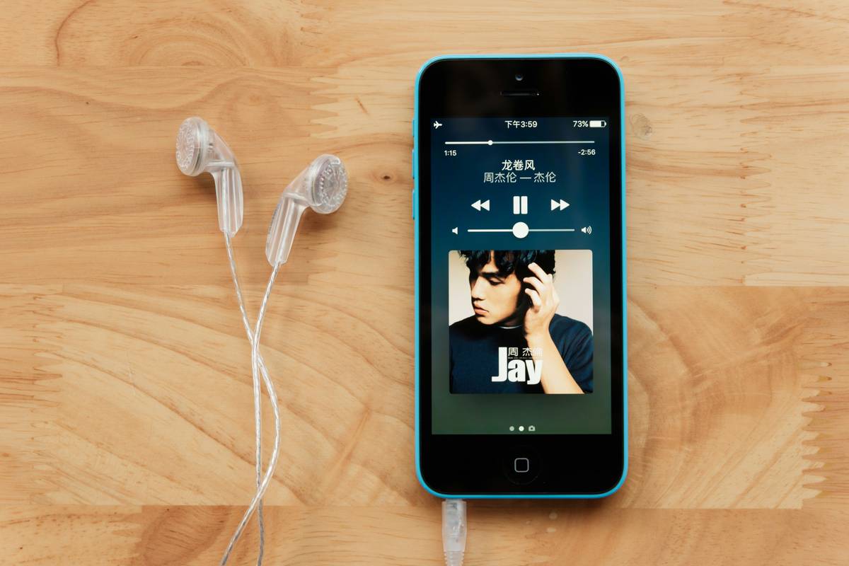 Infographic showing how podcast editorial teams select shows: Submission → Review → Shortlist → Feature. Includes icons for Apple Podcasts, Spotify, and Amazon Music.